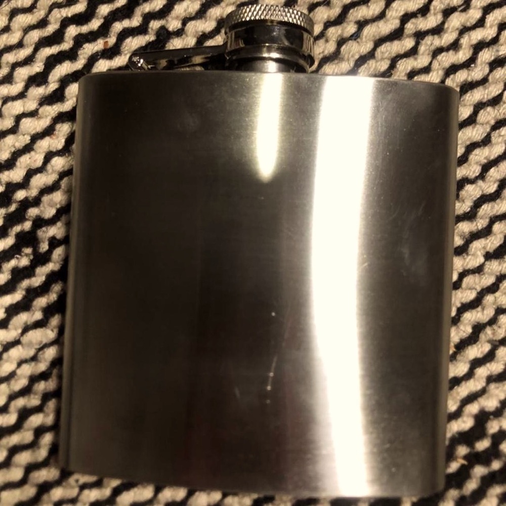 Silver stainless steel functional flask with screw on cap.